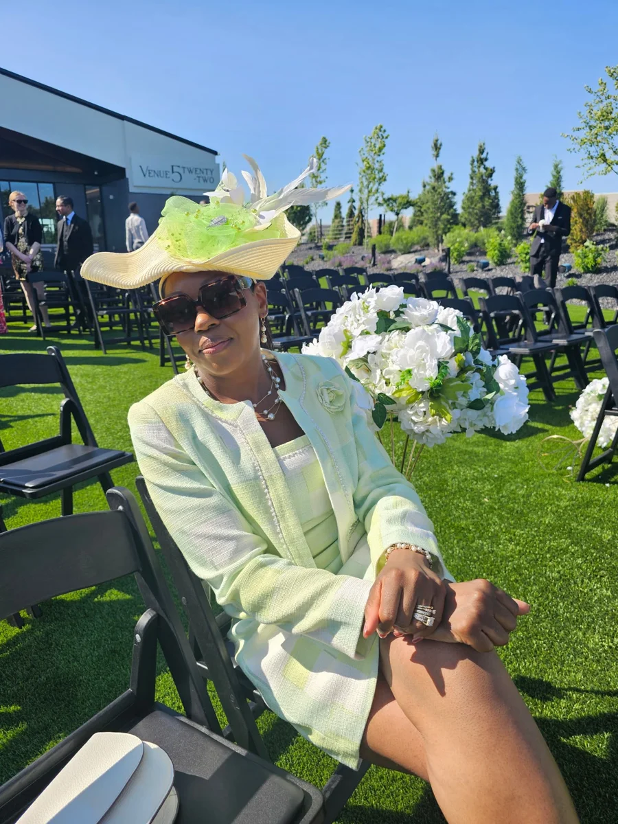 Agnes, founder of Tiny Tutors, seated outdoors in a pale green outfit and hat.